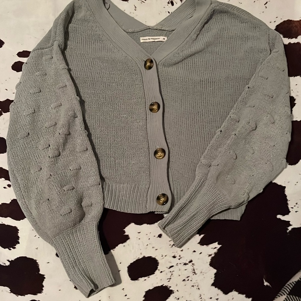 it is a sage green sweater.